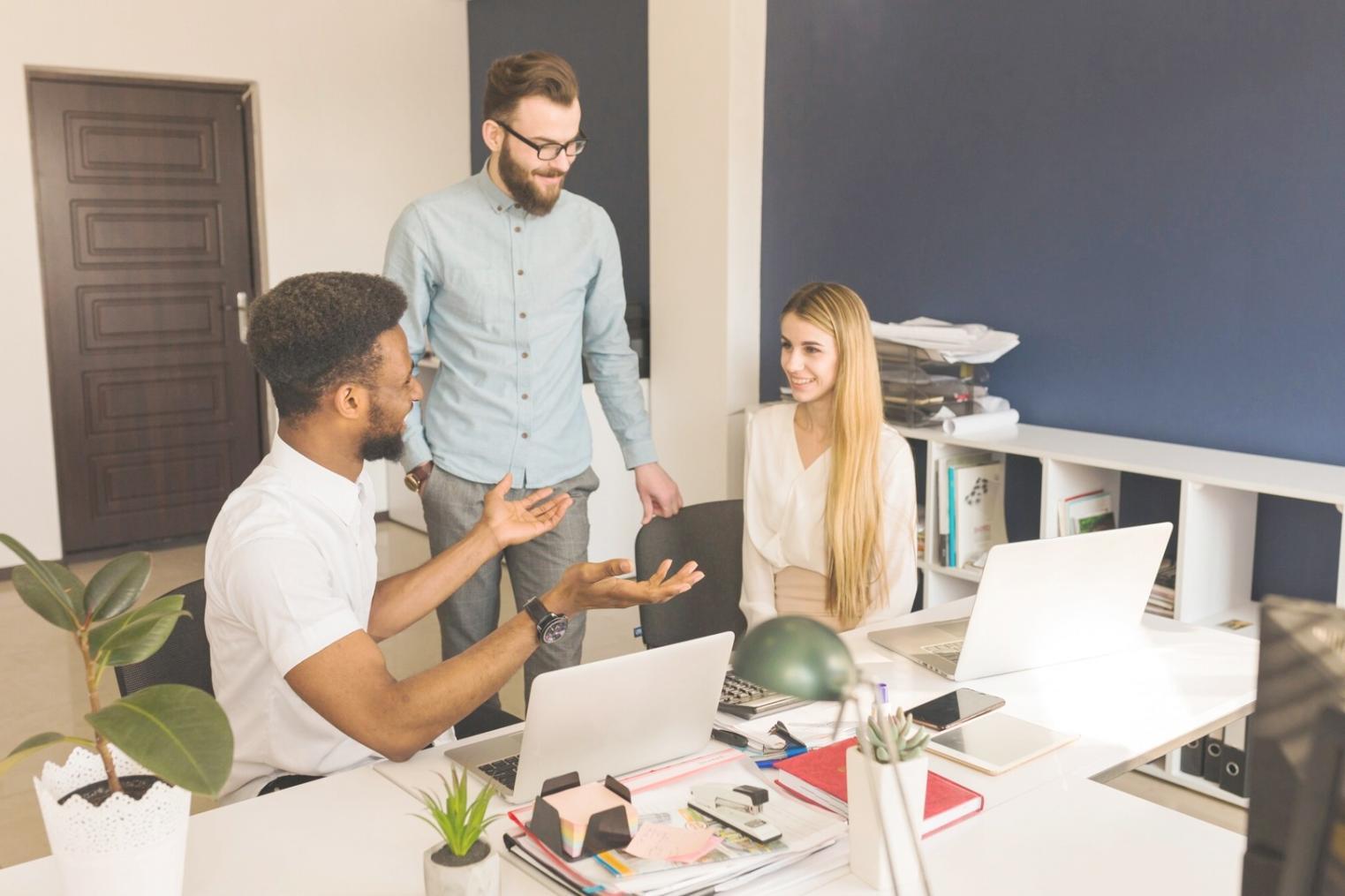 Team collaboration session showing engineers reviewing performance metrics and discussing optimization strategies