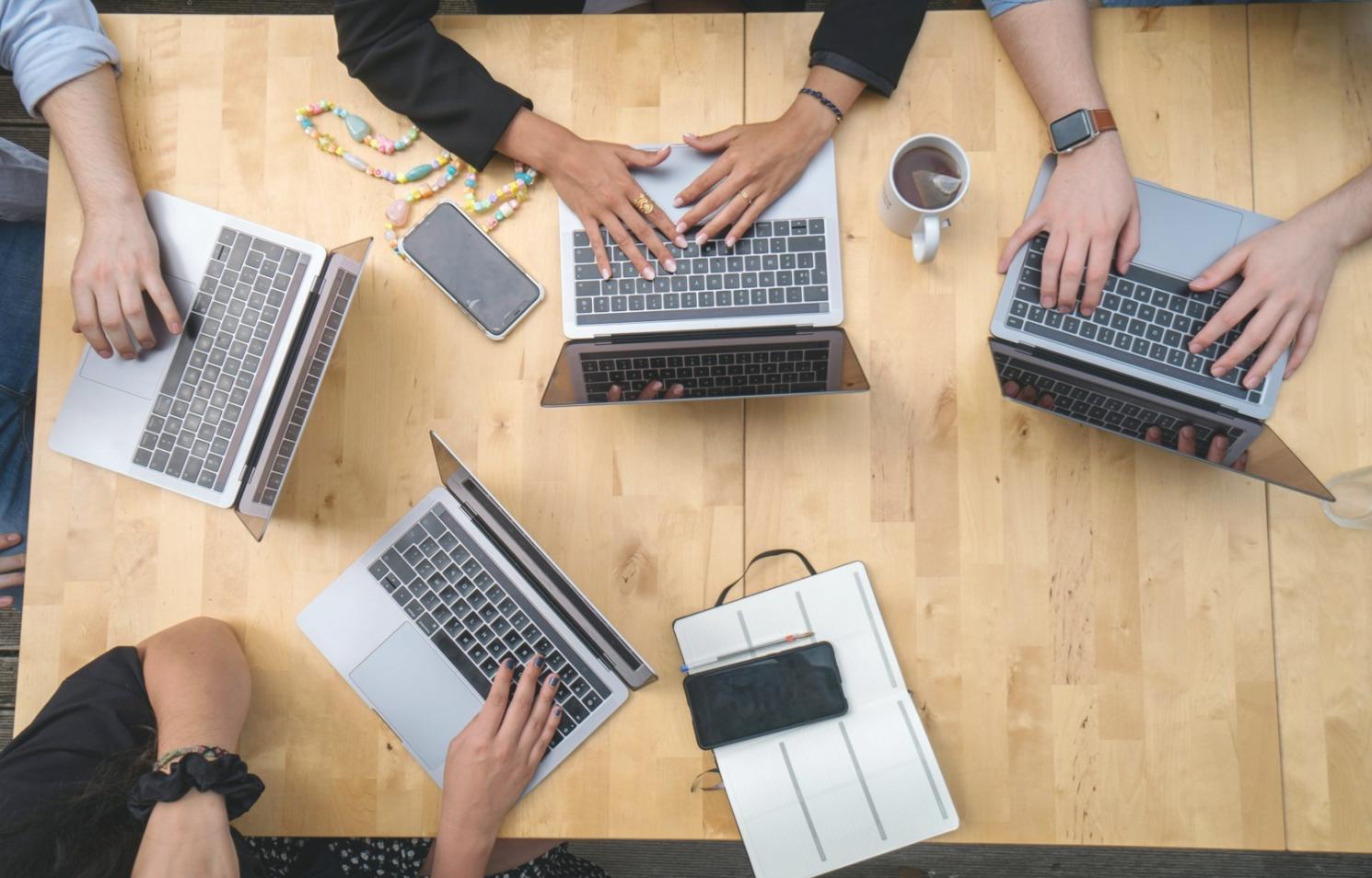 Modern office workspace with dual monitors showing performance testing dashboards and optimization tools